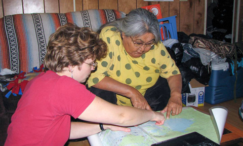 Dr. Olga Lovick (PhD) reviews Upper Tanana place names with the late Cora H. David, an Elder, storyteller and teacher, at David’s home in Tetlin, Alaska, in 2009