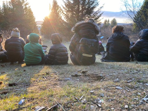 Students in outdoor sharing circle.